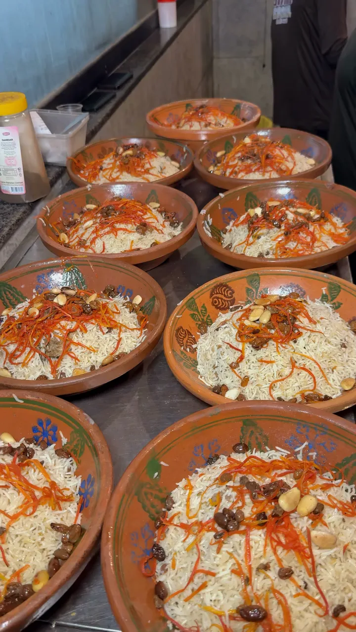 Rice bowls with carrots, raisins and nuts ready in Ghani Shinwari’s kitchen